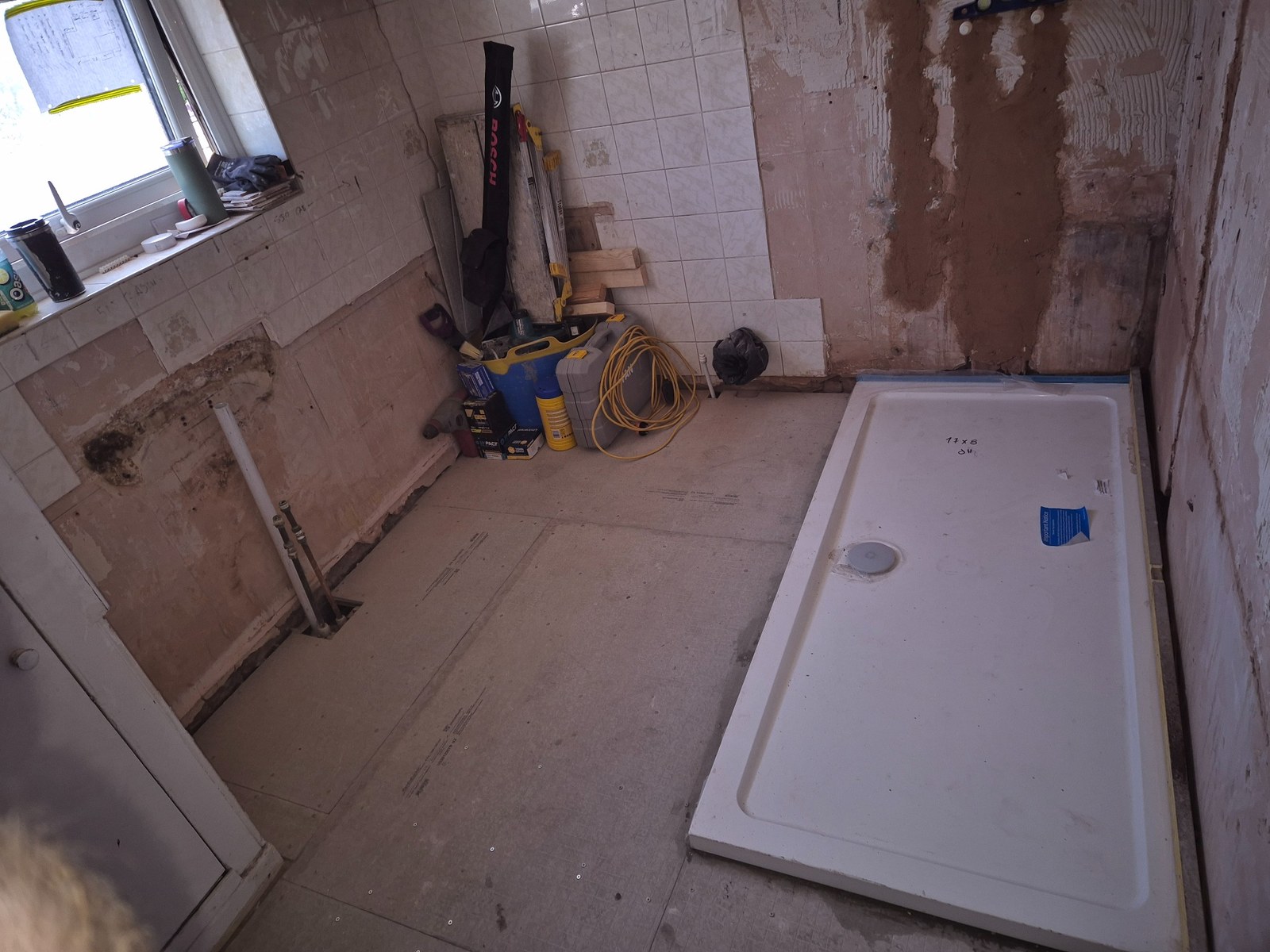 Wall finishes stripped back around the window ready for making good and new finishes
