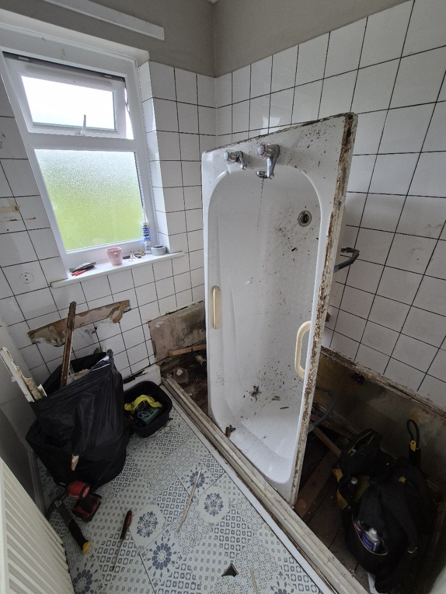 Existing bath removed to open up the floor and wall areas