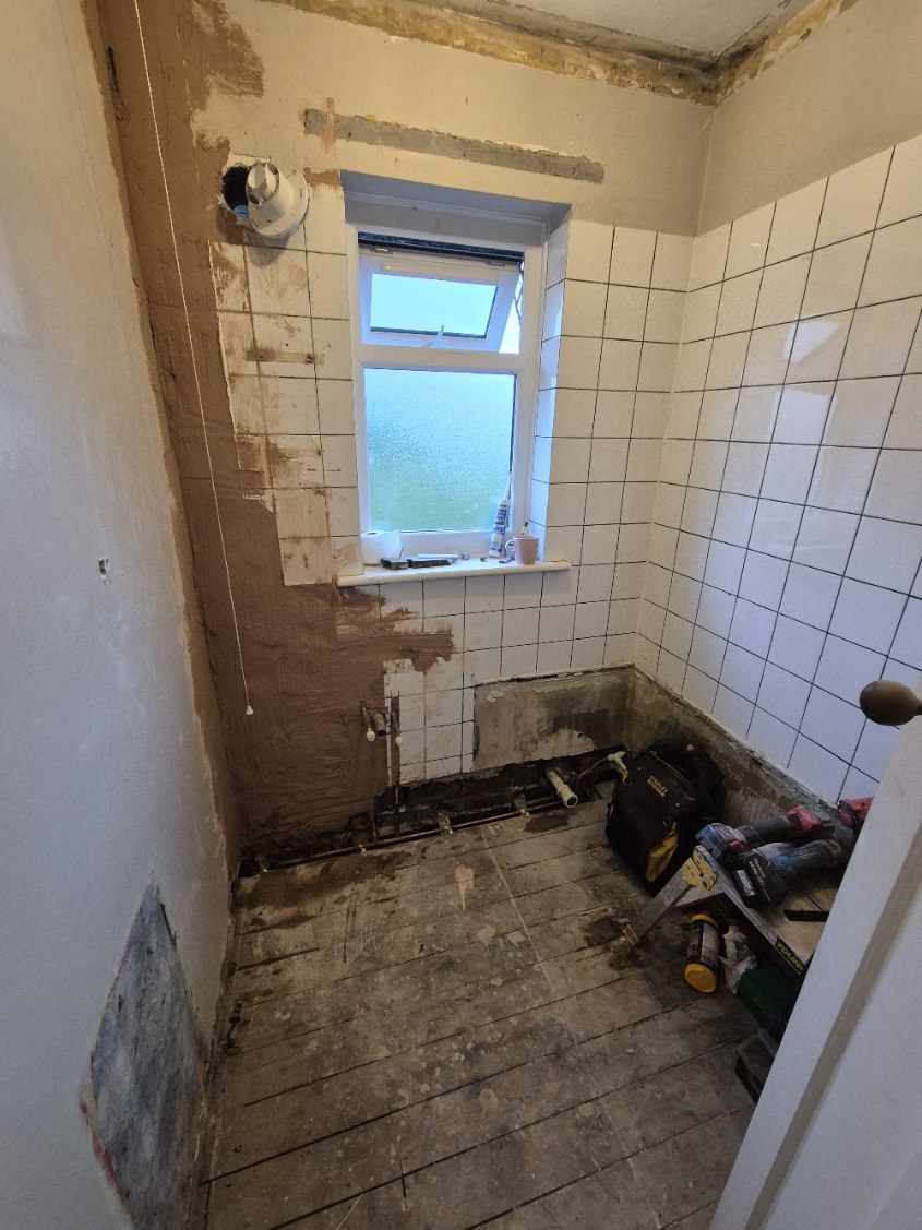 Wall finishes removed and the room opened up for preparation