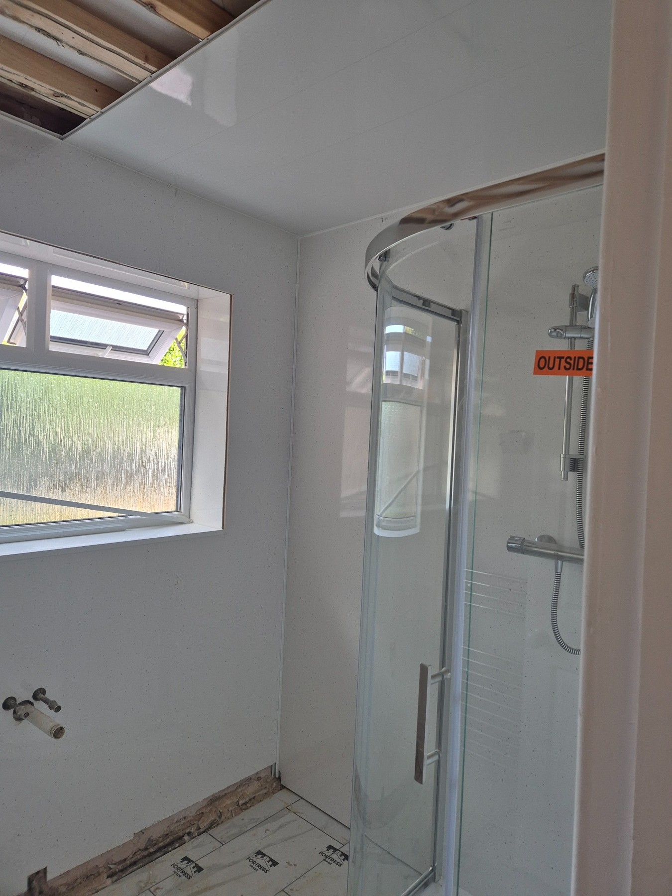 Bathroom installation with lighting and shower area preparation