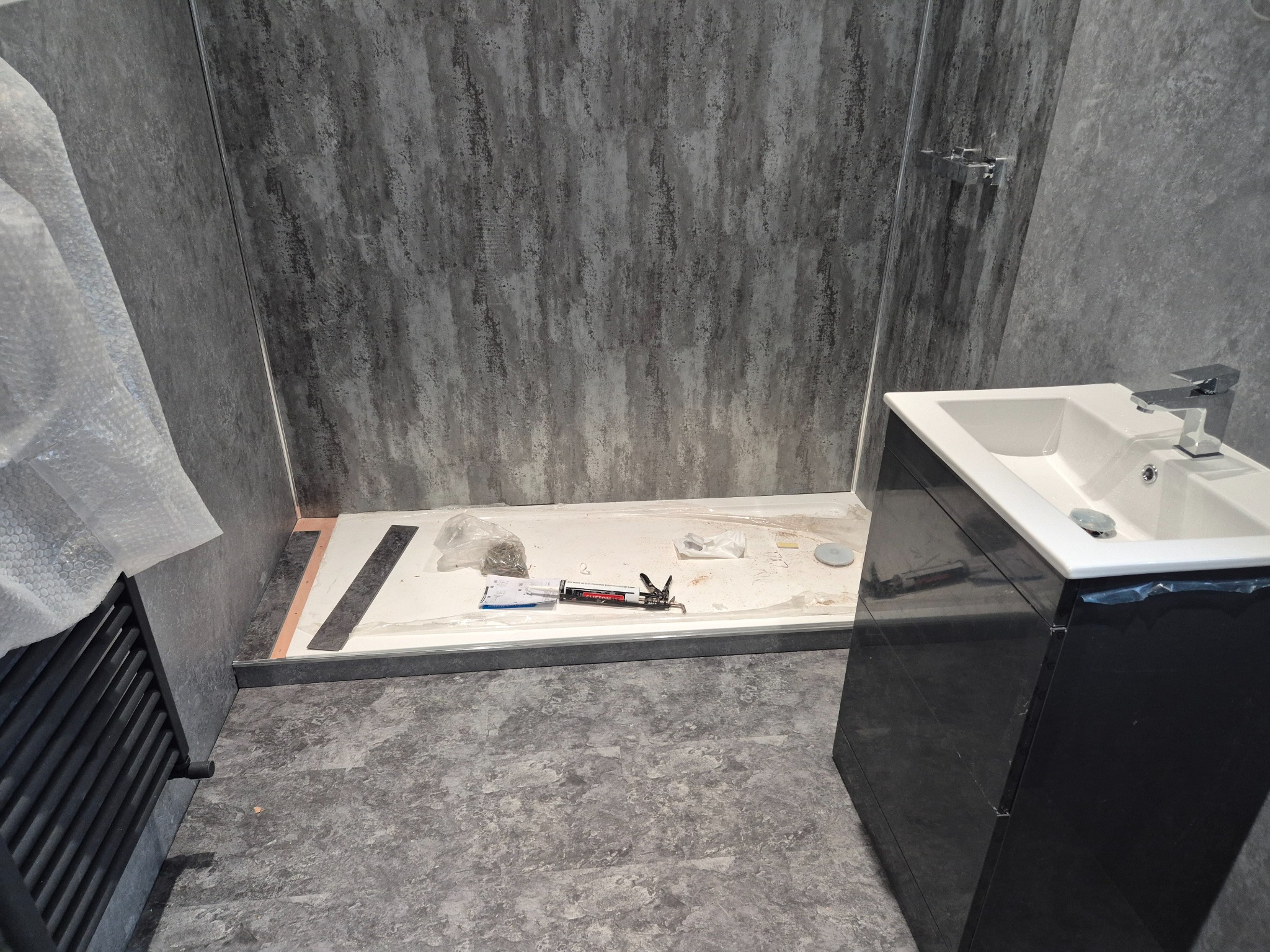 Finished shower and vanity area showing the waterproofed build carried through to its completed surfaces
