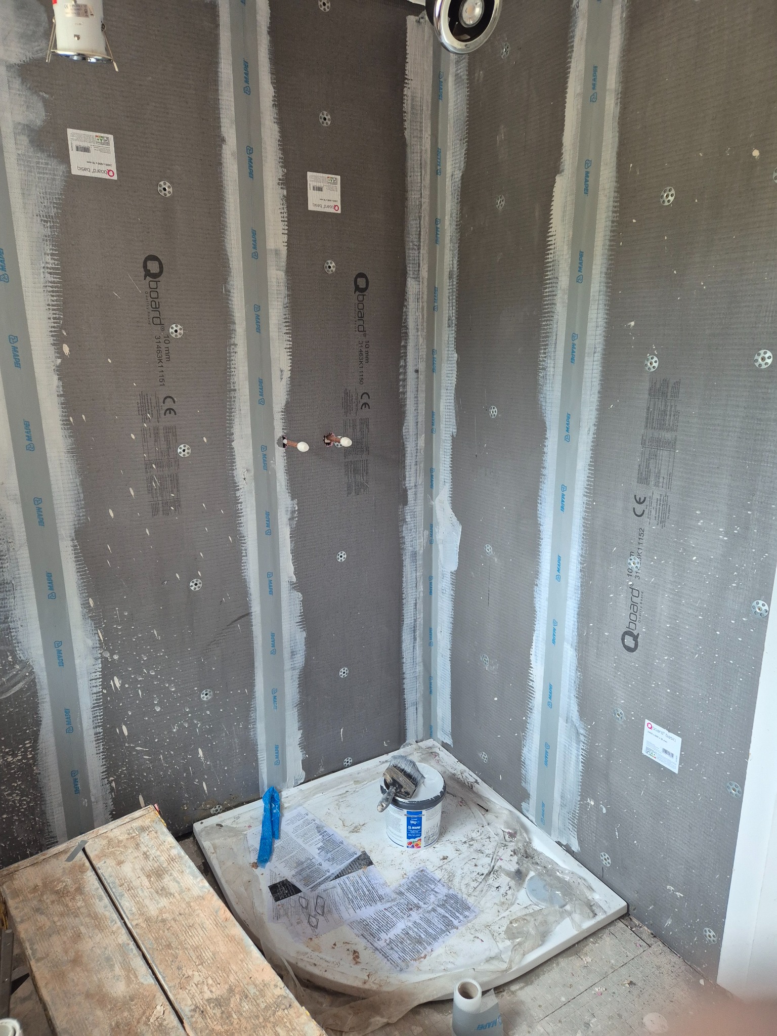QBoard wet-area boards fixed with joints, corners and service penetrations sealed before tiling