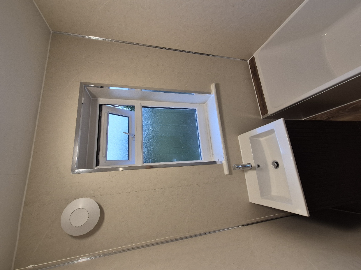 Bathroom extractor fan providing mechanical ventilation and moisture control